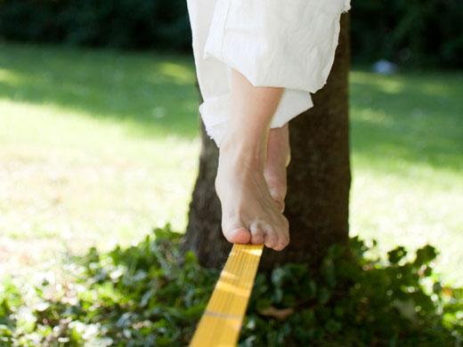 person walking barefoot on stretched strap